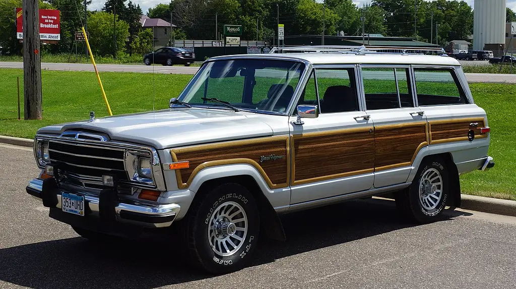 White Jeep Wagoneer with wood panels.