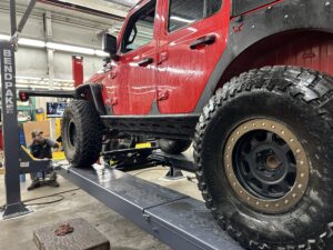 Red Jeep Wrangler on an Alignment Rack. 