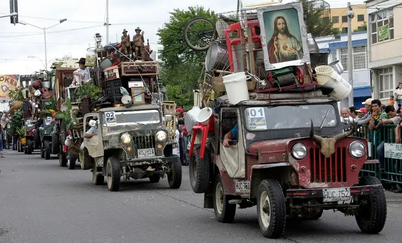 Willy's Jeeps piled high with stuff during the Yipao parade in Columbia.