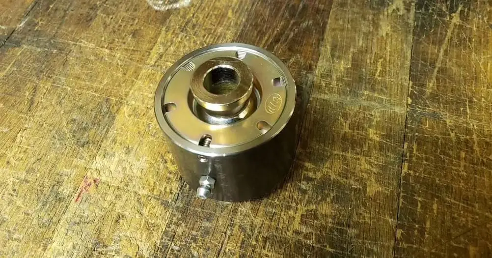 Assembled Summit Machine weld-on flex joint on a wooden surface.