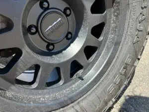 Close-up photo of a Method Race Wheel with a Baja Boss tire, showing the valve stem and tire details.
