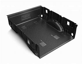 Black plastic drop-in bedliner fitted inside a pickup truck bed