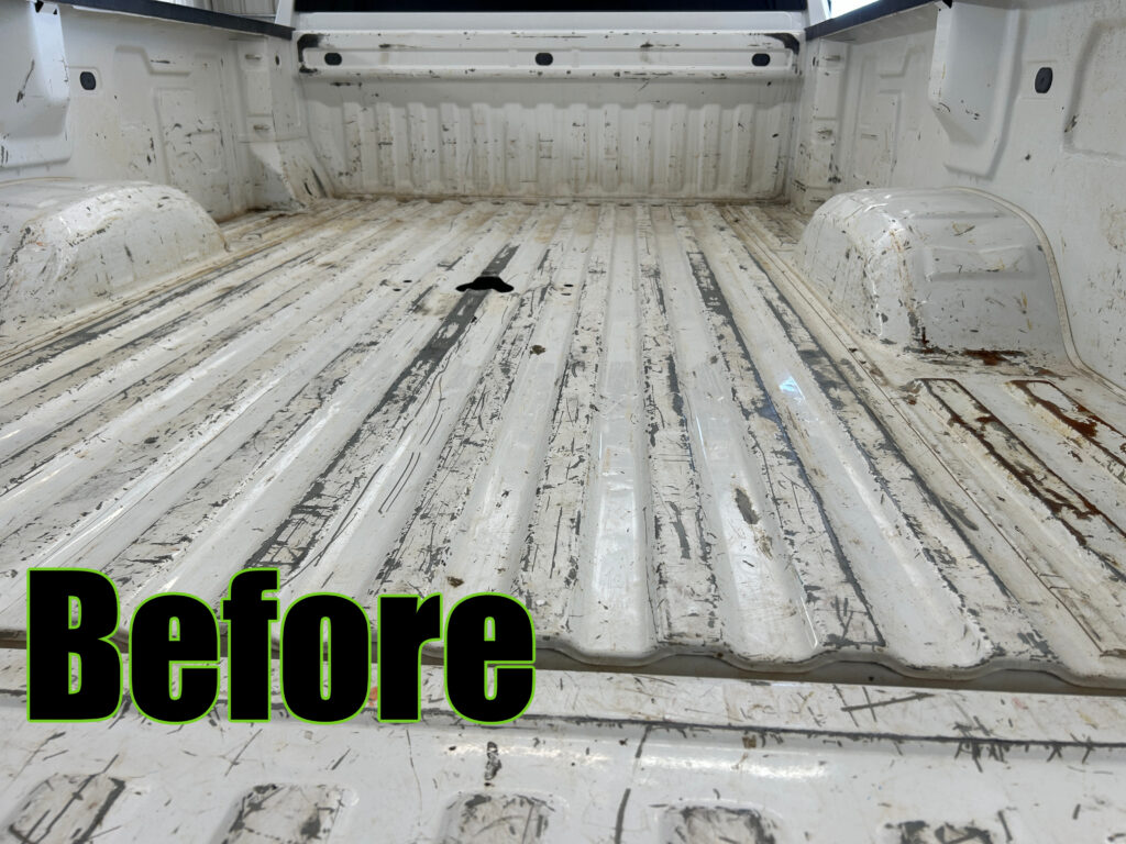Worn white pickup truck bed before spray-in bedliner installation showing scratches, paint wear, rust spots, and exposed metal.