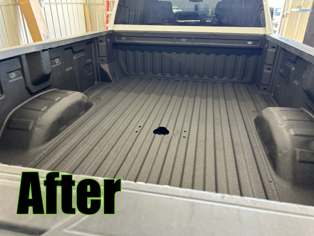 Pickup truck bed after professional spray-in bedliner installation featuring a durable textured black protective coating.