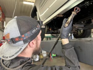 TNT Customs technician applying rustproofing treatment inside body panels and hard-to-reach vehicle cavities to help prevent corrosion.
